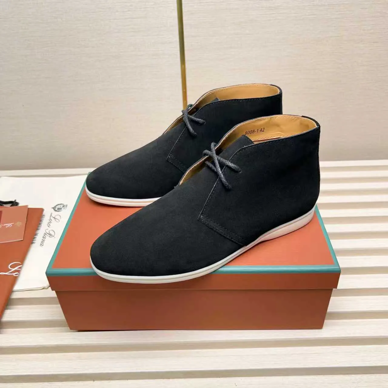 Men's Shoes 💰420 Loro Piana reimagines the desert boot—a modern, comfortable interpretation of a classic 1940s style. Crafted from suede calfskin, it exudes elegance. The tight texture of suede calfskin is not only durable but also looks casual and sophisticated. Add a timeless piece to your shoe collection, harmoniously blending comfort, style and Loro Piana's heritage of craftsmanship. Acetate satin detail on the inside White sole with LP lettering for added traction Space for a personalized signature on the heel Tonal suede trim Upper: 100% cow split suede Sole: 100% Rubber lining: Cow leather